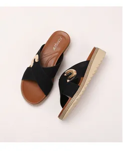 Close-up of bohemian platform flip flops with black straps and golden metal accents