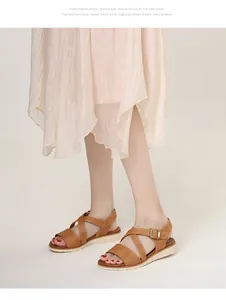 Detail of camel wedge sandals with cross straps and white textured non-slip sole