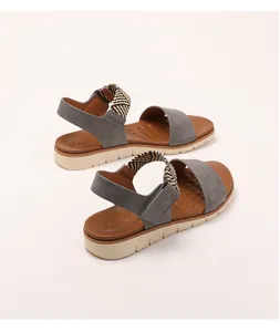 Detail view of women's wedge sandals with woven elastic straps and anti-slip textured footbed