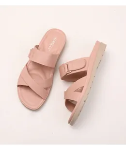 Detail shot of pink platform wedge slides with adjustable strap and textured sole