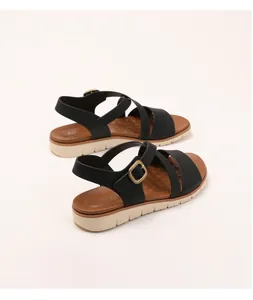Detail view of women wedge sandals with black cross straps and soft non-slip sawtooth sole