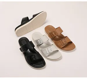 Detail of soft platform slide sandals showing non-slip sole and decorative buckles