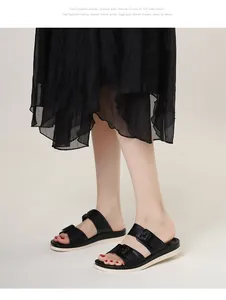 Detail of black double-strap slide sandals with fashion buckles and thick off-white soles