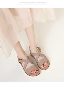 Close-up of tan wedge sandals with cross straps and gold buckles for summer vacation
