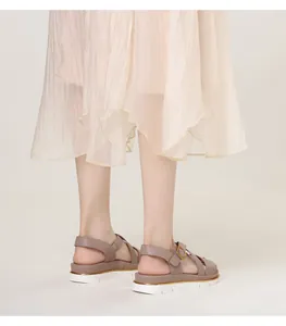 Detail view of stylish wedge sandals featuring a cross-strap design and thick serrated sole