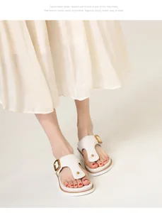 Detail of ivory platform thong sandals with gold square buckle and anti-slip sole
