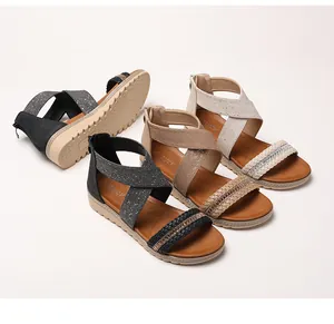 Detail of rhinestone braided straps and anti-slip rubber wedge sole on summer sandals