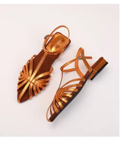 Detail of metallic bronze pointed-toe sandals with cutout straps and T-strap buckle