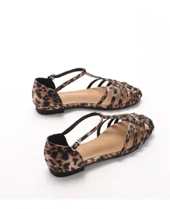 Top view of leopard print cage flat sandals with T-strap and silver buckle detail