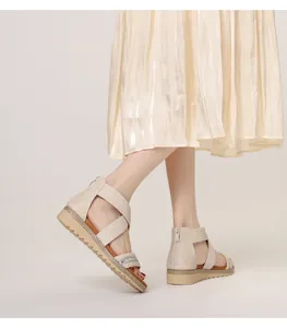 Close-up of bohemian wedge sandals featuring rhinestone straps and back zipper detail