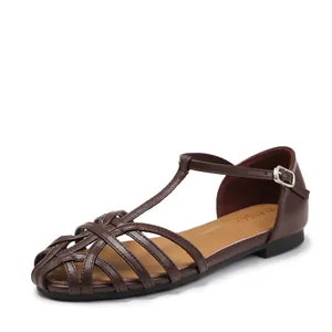 Women's woven hollow flat sandals in dark brown leather with buckled ankle strap