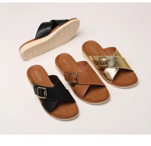 Close-up of stylish platform sandals with cross straps and gold buckles in three colors