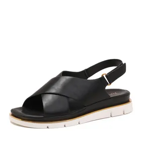 Stylish black cross-strap platform sandals with white rubber sole and gold metallic trim