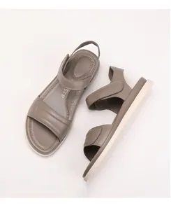 Macro detail of beige leather sandals with Velcro straps and cushioned anti-slip footbed