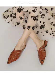 Detail of woven brown leather pointed-toe mule shoes styled with a long floral dress