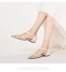 Detailed side view of beige woven cage sandals with adjustable metal buckle on foot