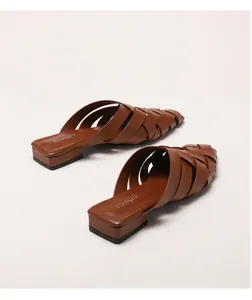 Detailed side view of brown woven pointed-toe mules with stylish low block heels