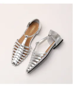 Detail view of silver woven fisherman sandals with T-strap buckle and metallic finish