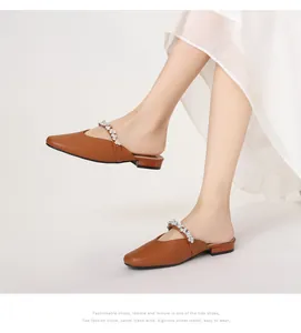 Close-up of brown pointed toe mule with sparkling rhinestone strap and matte finish