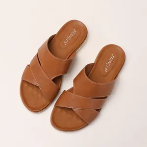 Brown platform slippers for women featuring cross bands and contrast stitching details