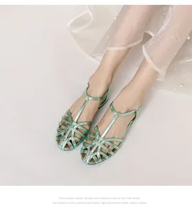 Close-up of retro green woven fisherman sandals with adjustable T-strap buckle closure