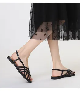 Detail of black woven roman sandals with cross straps and silver buckle for women