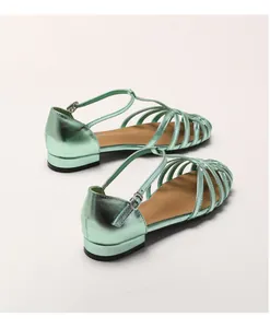 Close-up of metallic sage green caged sandals with ankle T-strap and buckle detail