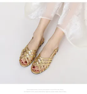 Close-up of golden woven cross-strap sandals with elegant ankle buckle and soft sole