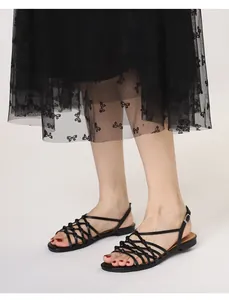 Detail view of handmade woven strappy Roman sandals with elegant knot design and buckle