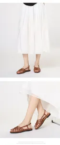 Detail of woven brown gladiator sandals with ankle buckle and soft flat soles