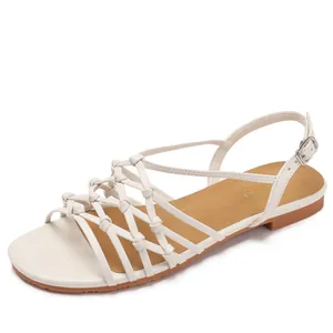 Handcrafted woven strappy Roman sandals for women in off-white with flat brown soles