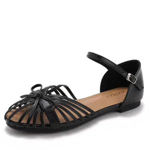 Black pointed toe flat sandals with bow detail and adjustable ankle strap for women