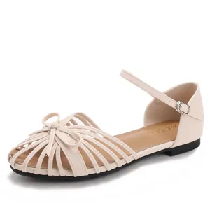 Elegant apricot flat sandals with hollow bow design and ankle buckle closure for women