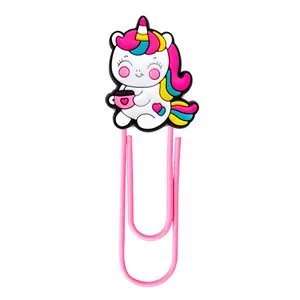 Close-up of pink metal paperclip featuring a cute cartoon PVC unicorn with a small cup