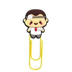 Macro detail of cartoon doctor PVC bookmark with yellow coated metal paperclip