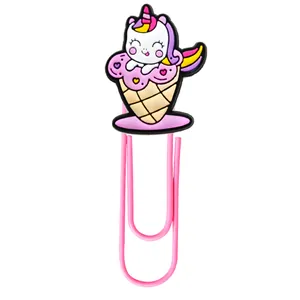 Close-up of pink coated metal paper clip with colorful PVC unicorn ice cream charm