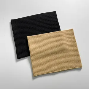 Detail of classic black and beige ribbed knit warm neck warmers for winter wear