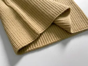 Detail of premium beige ribbed knit fabric showing soft texture and warm winter material