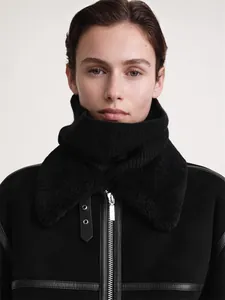 Close-up of winter knit neck warmer with plush collar and silver zipper details