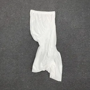 Detailed view of the textured white ruched fabric on this irregular fishtail skirt