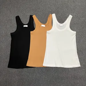 Flat lay of cotton ribbed U-neck tank tops in black, camel, and white neutral colors