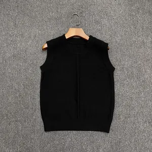 Detail of black wool knit vest featuring a round neck and vertical texture on a wooden hanger