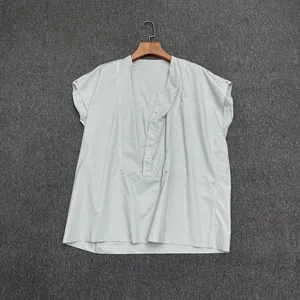 Detailed shot of sage green short sleeve blouse with small stand collar and button placket