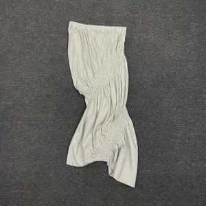 Detail view of the striped smocking texture and irregular fishtail hem of this midi skirt