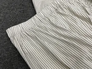 Detail of high waist elastic waistband on cream pinstripe irregular fishtail skirt