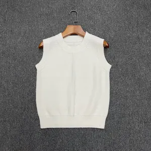 Detail of white knit vest with ribbed crew neck and vertical seam texture