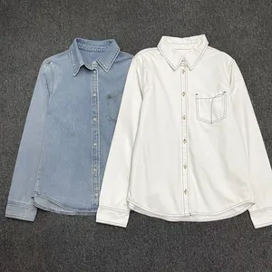 Close-up of light blue and white denim shirts showing collar and chest pocket details