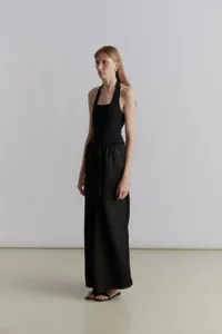 Minimalist black halter top paired with elastic drawstring waist wide-leg trousers