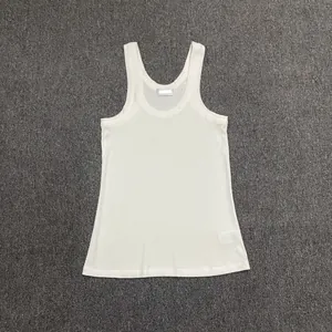 Detail of white ribbed cotton tank top showing U-neckline and breathable texture