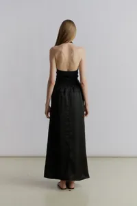 Detailed back view of a black satin halter neck dress showing the backless design